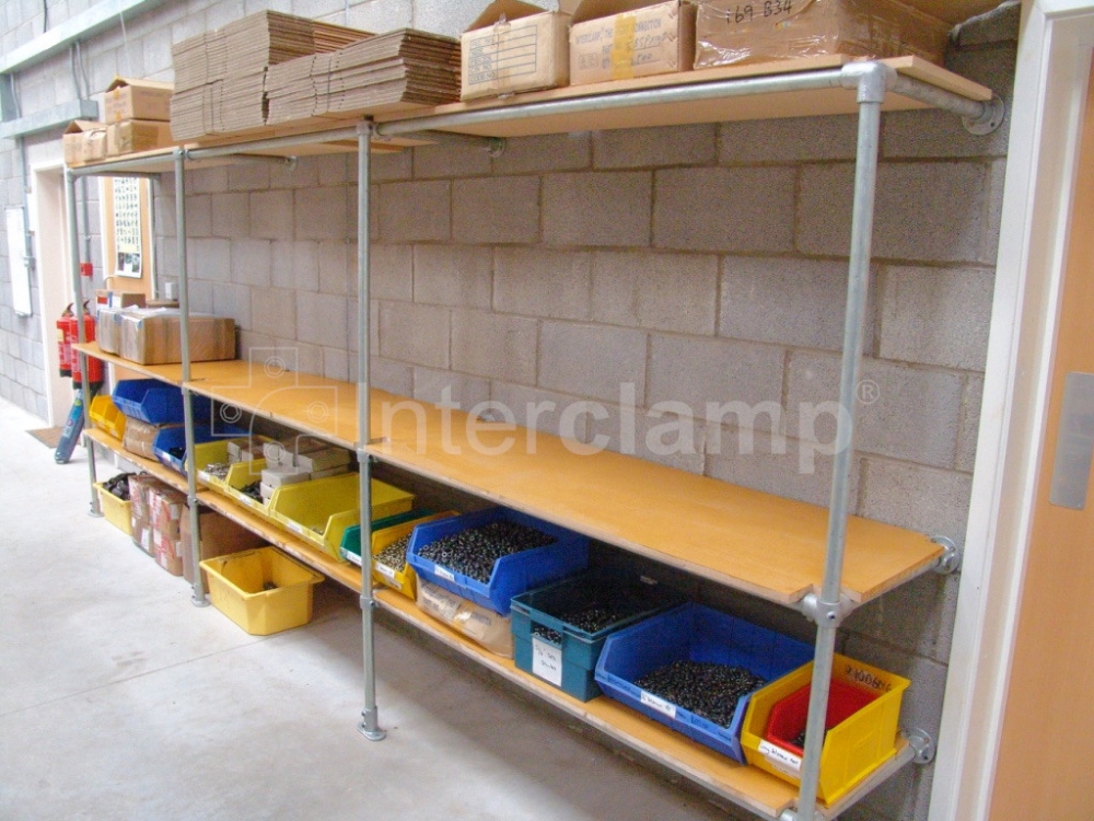 Storage solutions in a warehouse featuring Interclamp tube clamp fittings, demonstrating the ability to construct versatile and space-efficient racking and shelving systems.